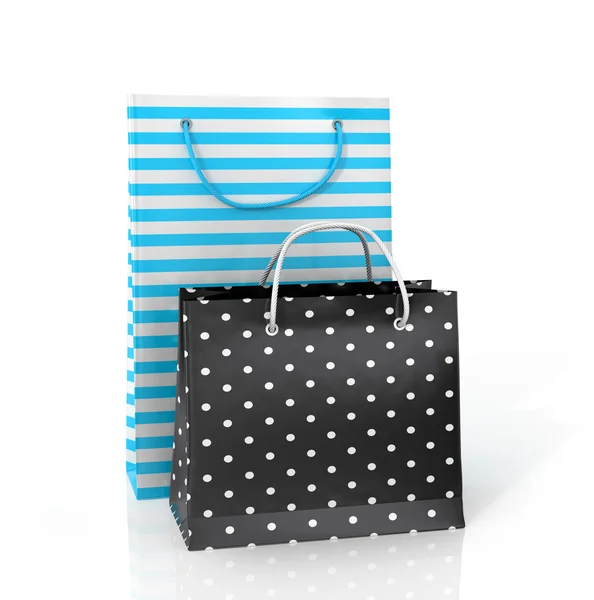 Dois sacos de papel coloridos para fazer compras em um fundo branco . — Fotografia de Stock