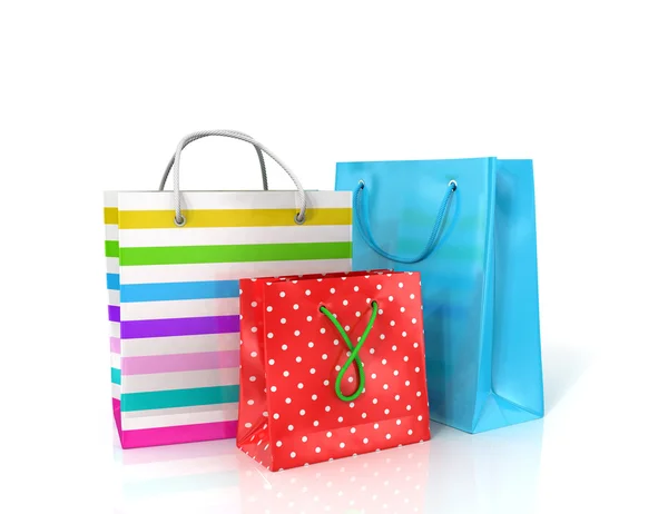 Tre colorati sacchetti di carta per lo shopping su uno sfondo bianco . — Foto Stock
