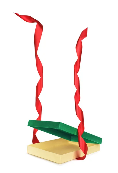 Empty Christmas gift box with red ribbon falling on an isolated — Stock Photo, Image