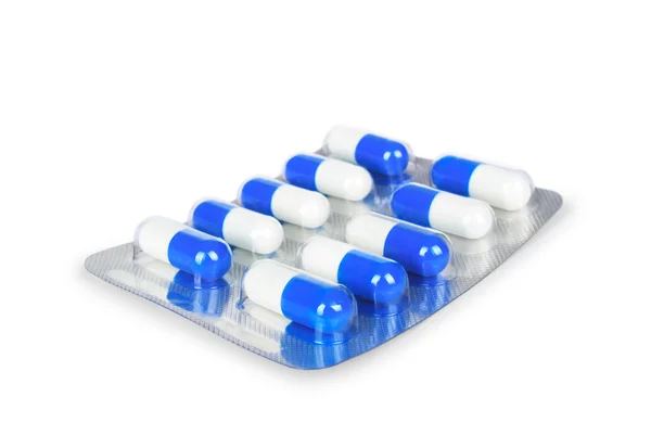 Cápsulas de medicamento azul en blister primer plano aislado en un — Foto de Stock