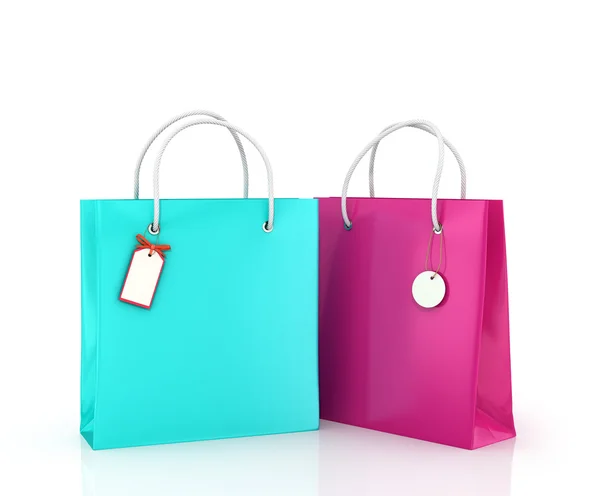 Dos bolsas de color con etiquetas sobre fondo blanco . — Foto de Stock