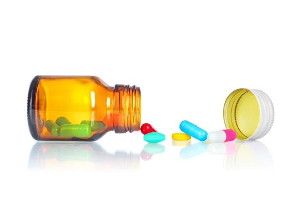Garrafa de pílulaComprimidos derramando fora do frasco de pílula — Fotografia de Stock