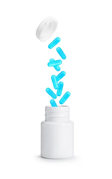 Pílulas voando para longe do frasco de plástico aberto isolado em branco — Fotografia de Stock