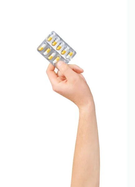 Hand holding medical drugs - full silver leaflet of white pills — Stock Photo, Image