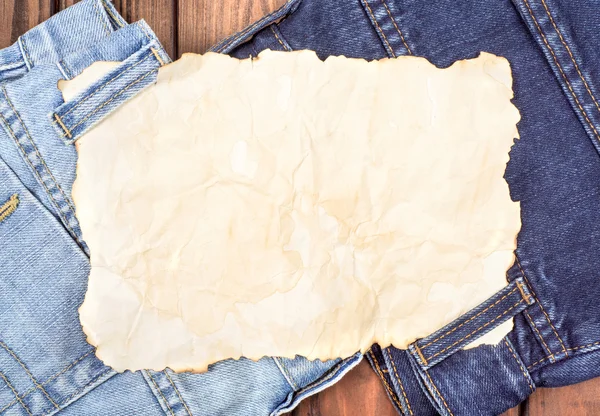 A sheet of paper on the jeans — Stock Photo, Image