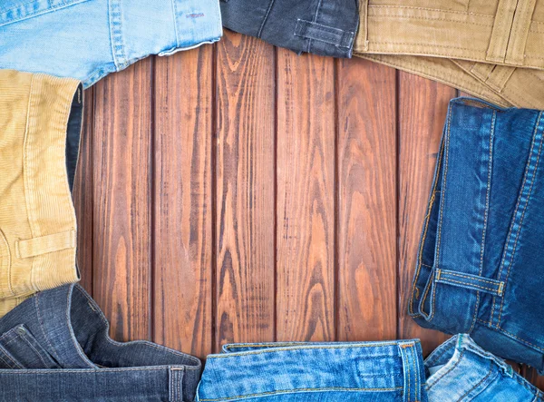 Jeans on a wooden table — Stock Photo, Image