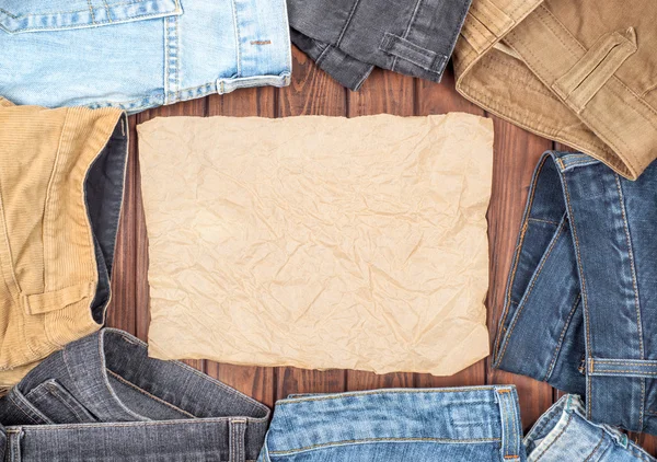 Jeans on a wooden table — Stock Photo, Image