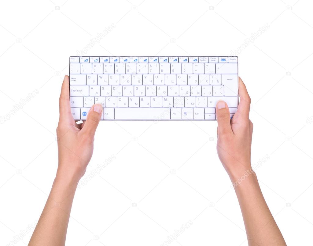 female hands holding the keyboard isolated on white