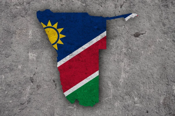 风化混凝土上的纳米比亚地图和国旗 — 图库照片