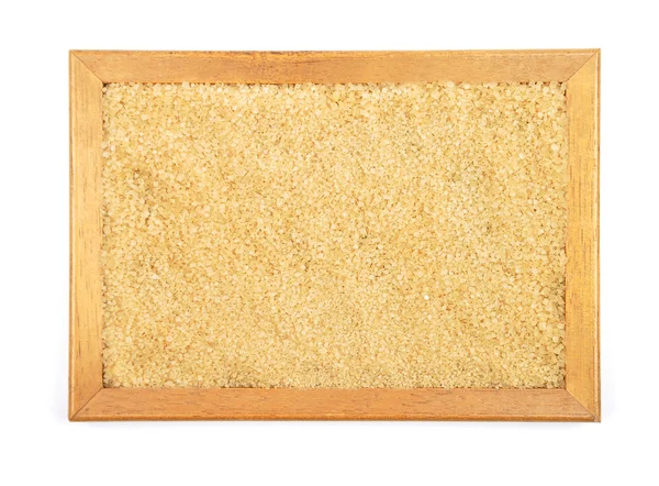 Brown cane sugar in frame — Stock Photo, Image