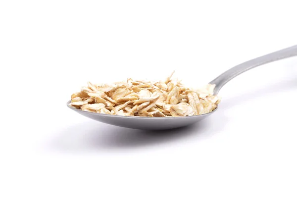 Oat flakes on spoon — Stock Photo, Image
