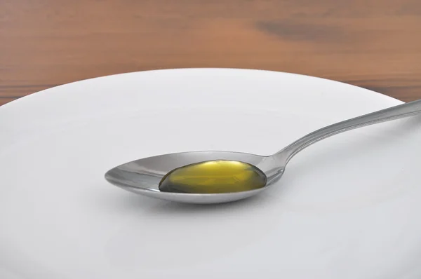 Spoon with olive oil — Stock Photo, Image