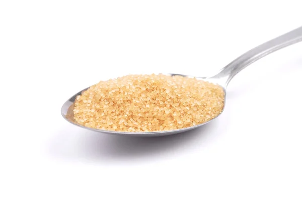 Brown cane sugar on spoon — Stock Photo, Image