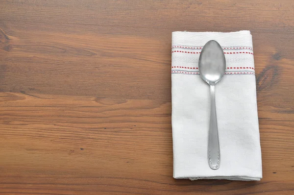 Old spoon on cloth — Stock Photo, Image