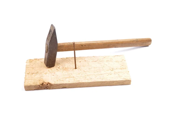 Hammer with nail and board — Stock Photo, Image