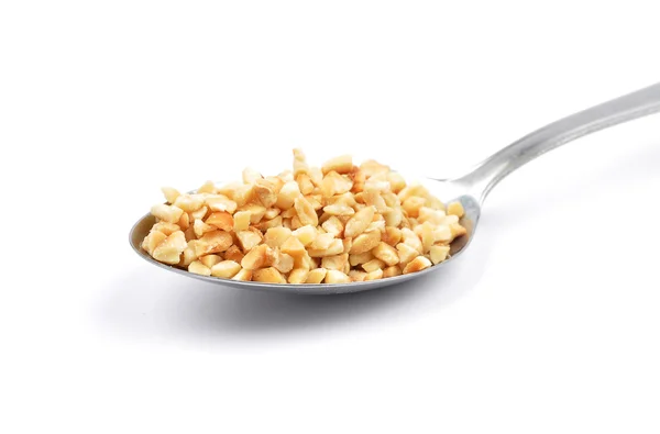 Minced hazelnuts on spoon — Stock Photo, Image