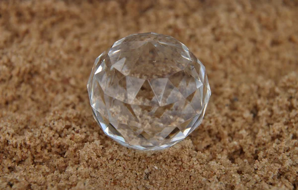 Crystal ball on sand — Stok fotoğraf