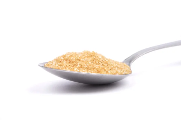 Brown cane sugar on spoon — Stock Photo, Image