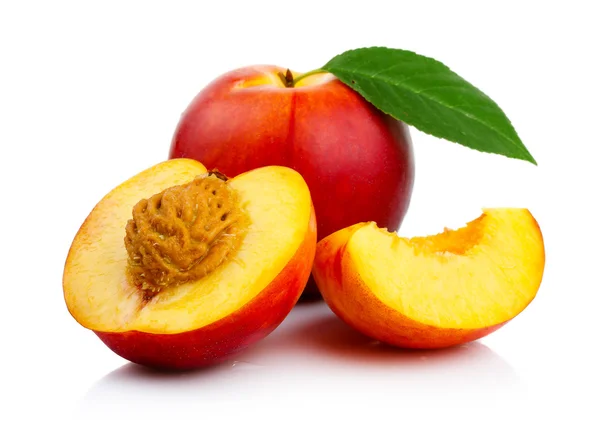 Peach fruits with slice and green leaves isolated — Stock Photo, Image