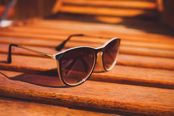 Sunglasses lie  on sun lounger wood Stock Image