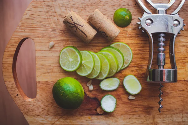 Lime slices corkscrew, cork and wine stains — Stock Photo, Image