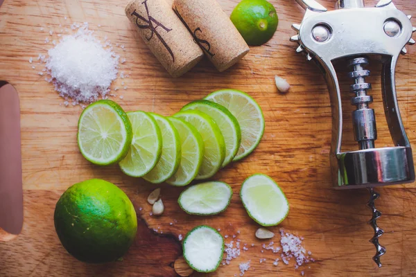 Lime slices corkscrew, cork and wine stains — Stock Photo, Image