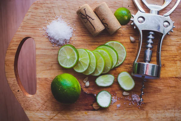 Lime slices corkscrew, cork and wine stains — Stock Photo, Image