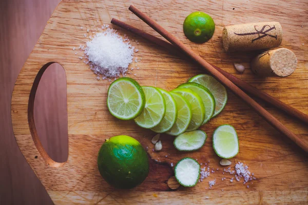 Lime slices, sugar, cork and Chinese sticks — Stock Photo, Image