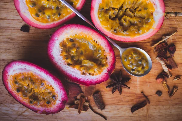 Passion fruit pulp and seed board, spoon, spices — Stock Photo, Image