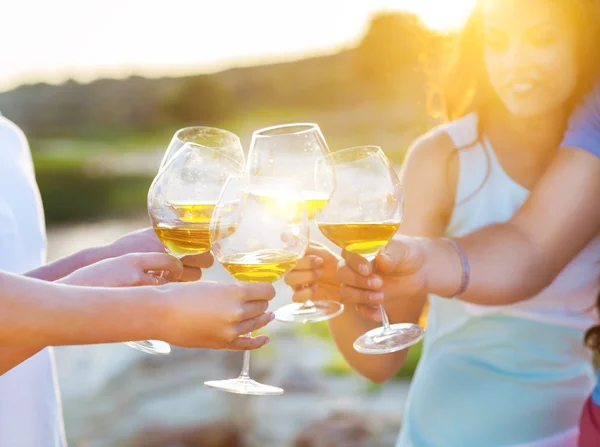 People holding glasses of white wine making a toast — Stock Photo, Image