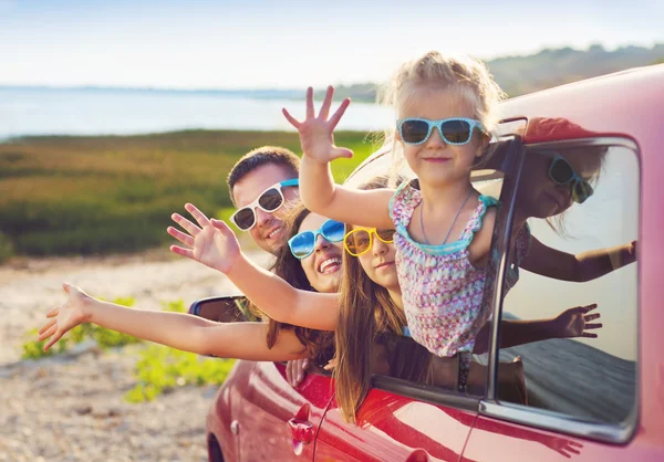 Portret van een lachende gezin met twee kinderen op het strand in de c — Stockfoto