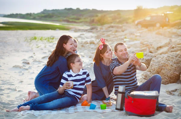 Family of five doing selfy at the picnic on the beach — Stock Photo, Image