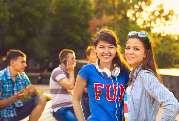 Cute young beautiful teens sitting in city near university after — Stock Photo, Image