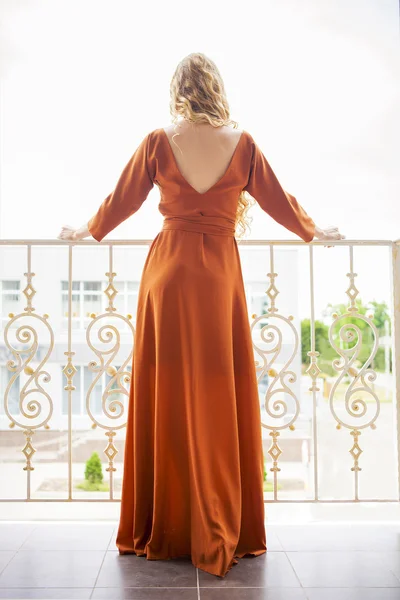 Beautiful blond woman in long dress — Stock Photo, Image