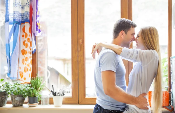 Happy couple hugging in the kitchen — Stock Photo, Image