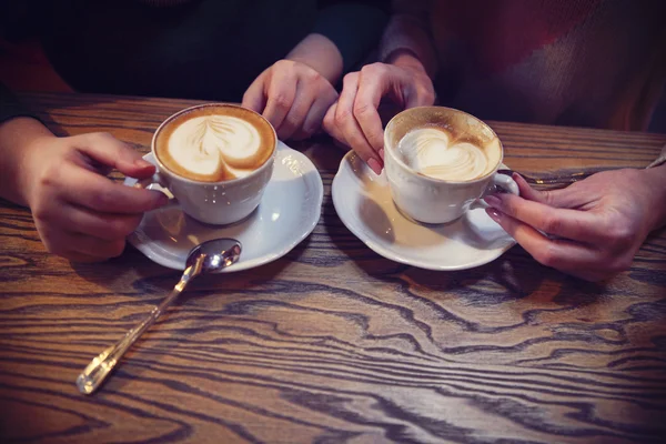 Female friends hands holding cups of coffee — Stock Photo, Image