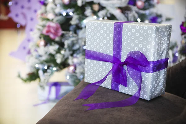 Christmas present by the Christmas tree — Stock Photo, Image