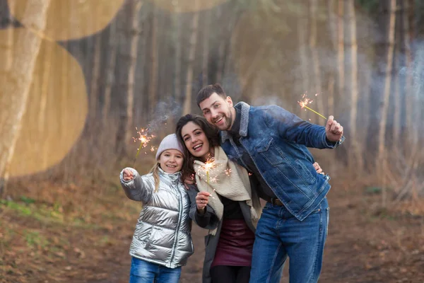 Cheerful Young Family Daughter Dressed Warm Clothes Sparklers Hands Embracing — Stock Photo, Image