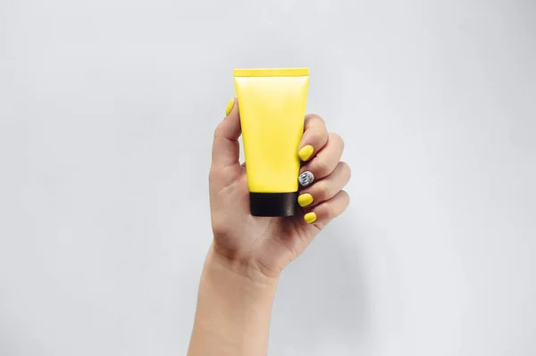 Top View Anonymous Female Manicured Hand Demonstrating Blank Tube Cream — Stock Photo, Image