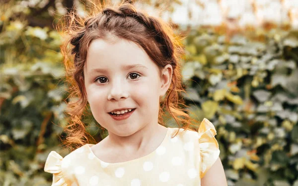 Cute Little Girl Kręconymi Włosami Uśmiecha Się Patrząc Aparat Stojąc — Zdjęcie stockowe