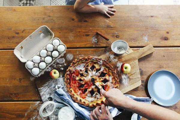 Shora Babička Krájí Čerstvý Ovocný Koláč Dřevěném Stole Blízkosti Ingrediencí — Stock fotografie