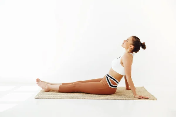 Junge Brünette Frau Sportbekleidung Sitzt Auf Matten Und Macht Yoga — Stockfoto