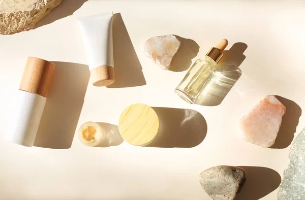 Top View Bottles Various Cosmetic Products Placed Amidst Stones White — Stock Photo, Image