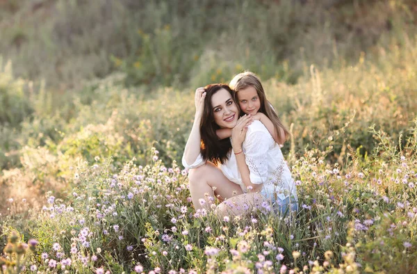 Smiling Mother Daughter Cuddling Gently Blooming Meadow While Spending Weekend — Stock Photo, Image