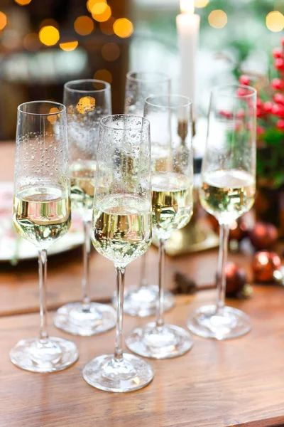 Set Champagne Glasses Wooden Table Candles Blurred Wall Christmas Tree — Stock Photo, Image