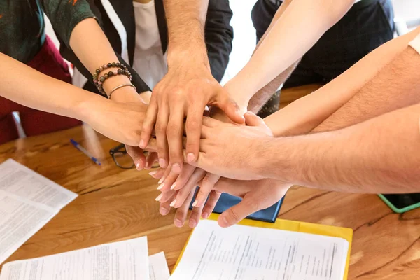 Business people folding their hands together. Team and sucsess concept