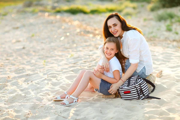 Loving Mother Kissing Adorable Girl Forehead While Sitting Together Shore — Stock Photo, Image