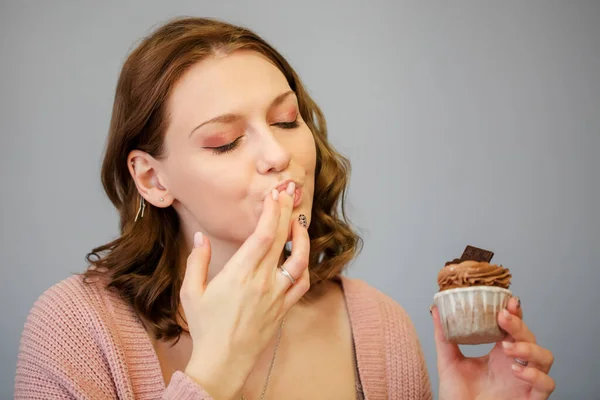 Delighted Female Closed Eyes Delicious Cupcake Smiling While Having Fun — Stock Photo, Image