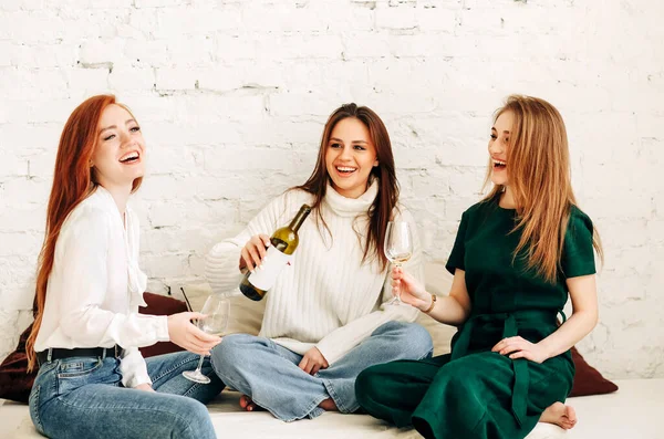 Cheerful Young Women Glasses Wine Smiling While Resting Couch Brick — Stock Photo, Image