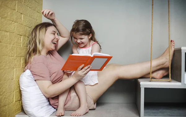 Rahatlamış Anne Küçük Kızı Ellerinde Kitapla Oturma Odasında Rahat Bir — Stok fotoğraf